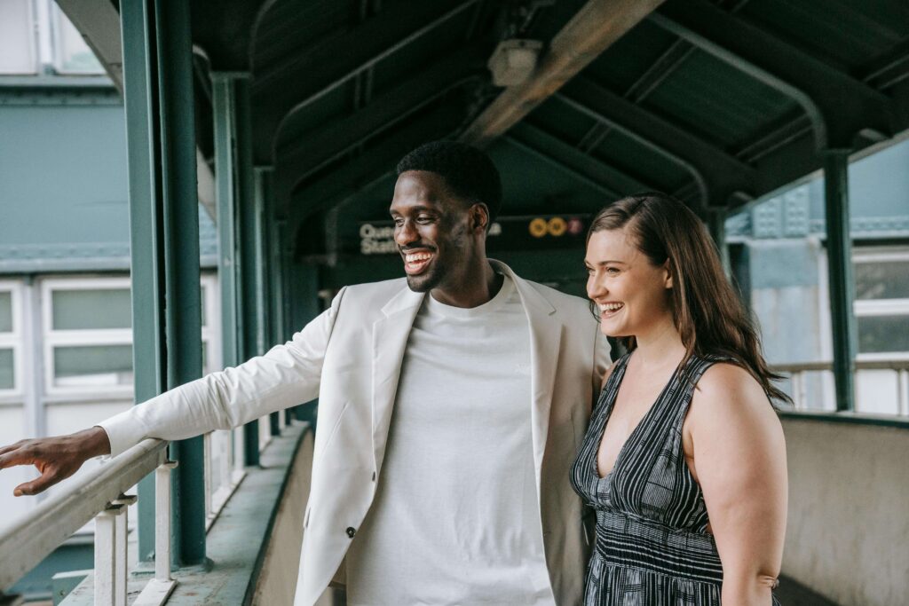 A smiling couple standing together on a ferry deck, looking relaxed and connected. Strengthen self-trust and connection through relationship therapy in Los Angeles, CA.