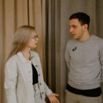 A Relationship Therapist’s Guide to the 5 Types of Boundaries in Relationships Every Couple Should Know A couple having a serious conversation while standing and facing each other indoors. Learn to communicate your limits clearly with relationship therapy in Los Angeles, CA.