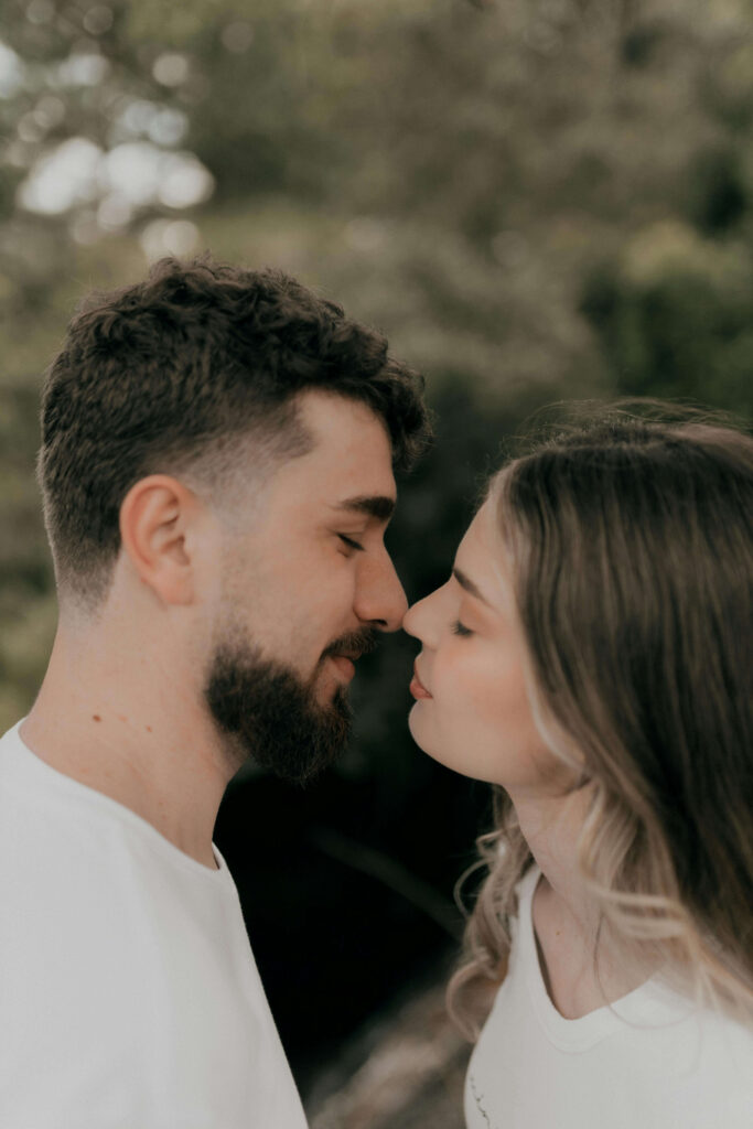 Couple with foreheads touching in tender moment outdoors. Create a relationship where vulnerability feels safe with support from relationship therapy in Los Angeles, CA.
