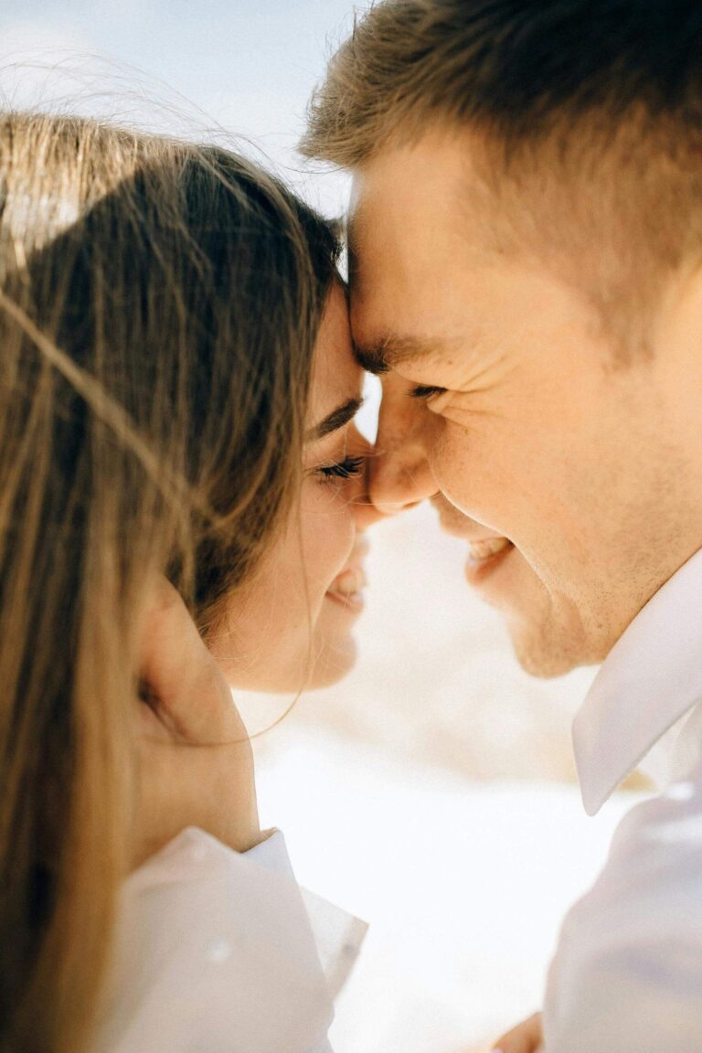 Close-up of couple with foreheads touching and smiling. Build self-respect that allows authentic closeness to exist through relationship therapy in Los Angeles, CA.